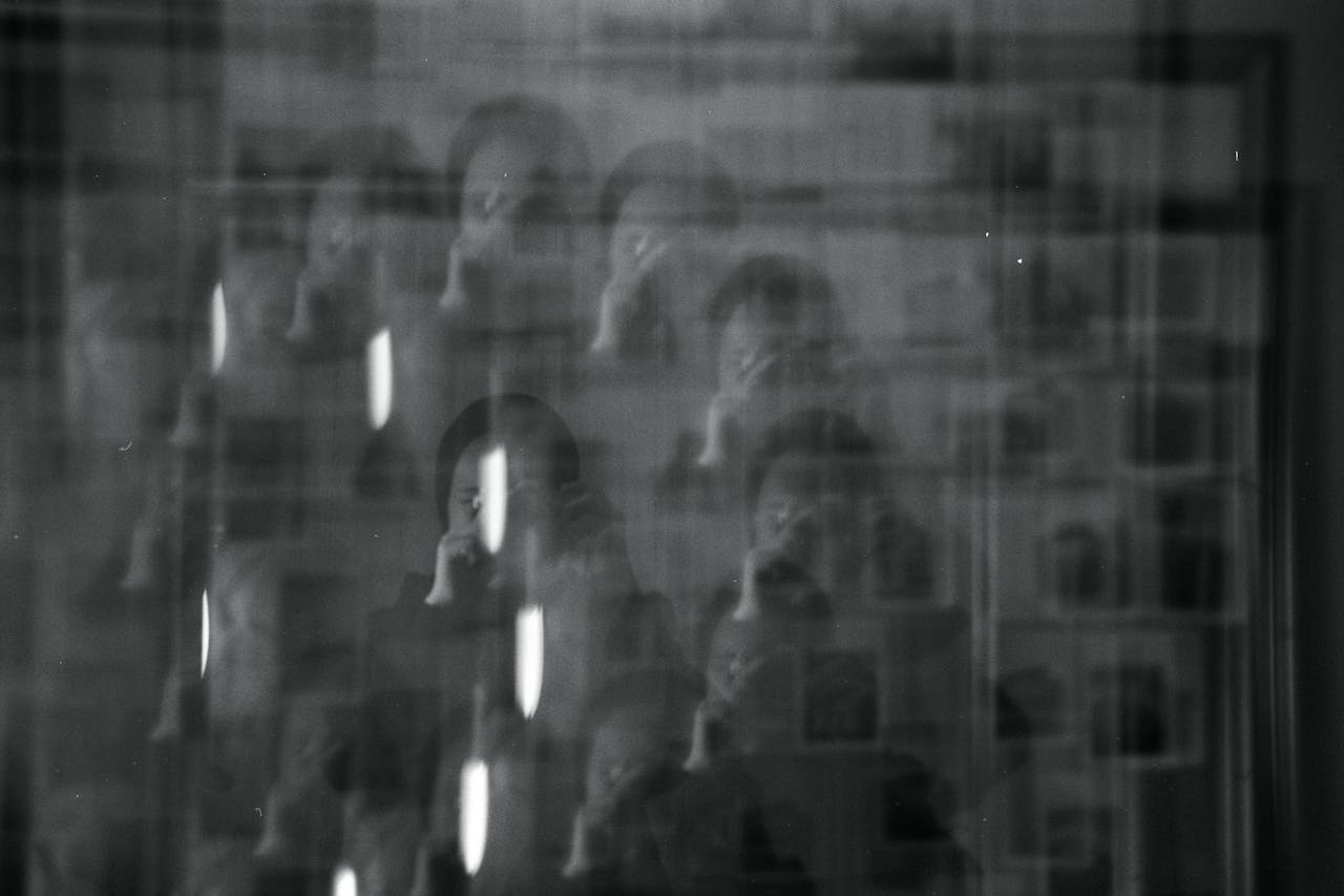 A black and white photo of a man in a mirror